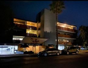 Redwood City apartment for rent - a building with cars parked in front of it at night