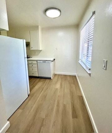 San Jose apartment for rent - A kitchen with a white refrigerator and wooden floors.