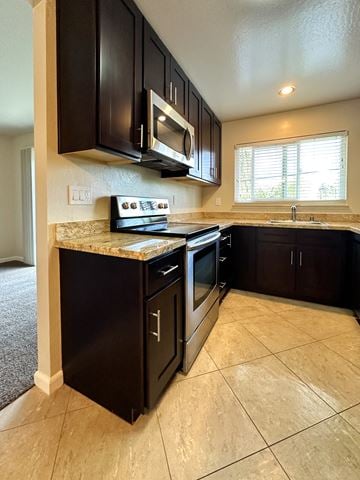 Mountain View apartment for rent - A kitchen with black cabinets and a granite countertop.