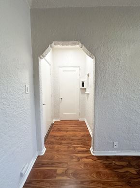 San Jose apartment for rent - A hallway with a white door and wooden floors.