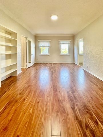 San Jose apartment for rent - A room with wooden floors and white walls.