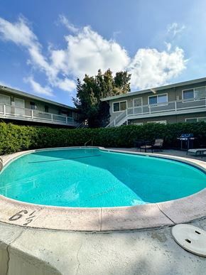 San Jose apartment for rent - a swimming pool with an apartment building in the background