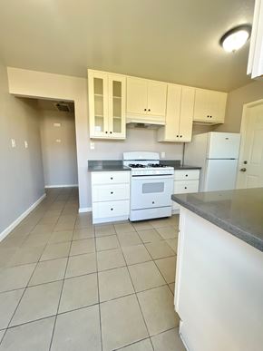 Castro Valley apartment for rent - A kitchen with white cabinets and appliances.