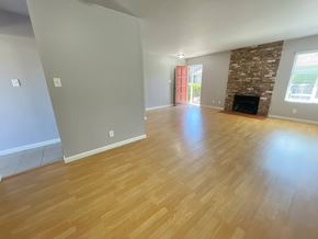 Castro Valley apartment for rent - A room with wooden flooring and a stone fireplace.