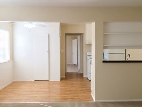 San Jose apartment for rent - an empty living room with a hard wood floor and a hallway to a kitchen