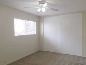 San Jose apartment for rent - an empty living room with a ceiling fan and a window