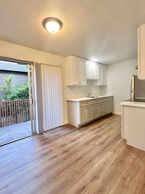 South San Francisco apartment for rent - A kitchen with white cabinets and a wooden floor.