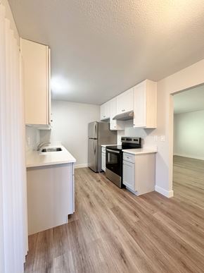 South San Francisco apartment for rent - A kitchen with white cabinets and wooden floors.