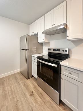 South San Francisco apartment for rent - A kitchen with a stainless steel refrigerator, oven, and cabinets.