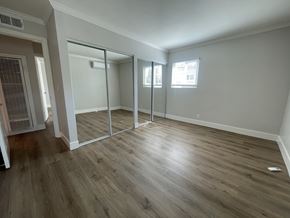Cupertino apartment for rent - A room with a sliding glass door and wood flooring.