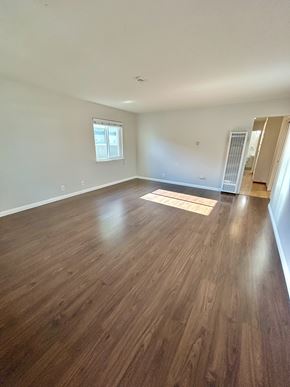 San Jose triplex for rent - A room with wooden flooring and a window.