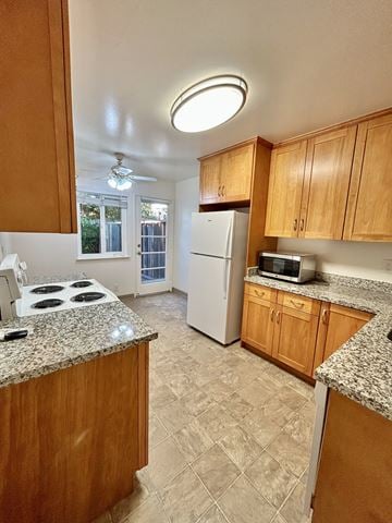 San Jose triplex for rent - A kitchen with wooden cabinets and a granite countertop.