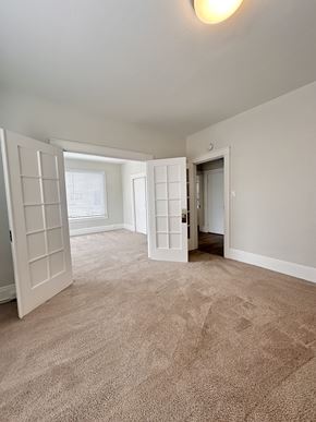San Francisco apartment for rent - A room with a carpeted floor and two doors.