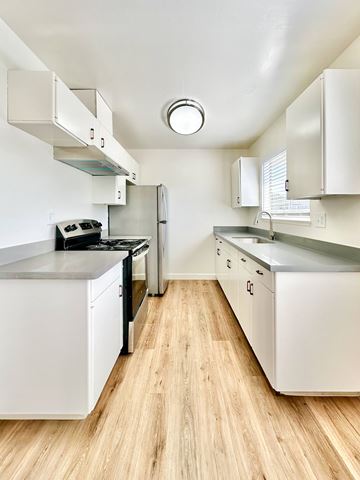 Santa Clara apartment for rent - a kitchen with stainless steel appliances and white cabinets