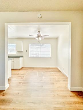 Santa Clara apartment for rent - an empty living room with a ceiling fan and a kitchen