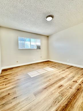 Santa Clara apartment for rent - an empty living room with wood flooring and a window