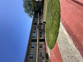 Newark apartment for rent - A tall building with a red track on the ground.