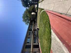 Newark apartment for rent - A tall building with a red curb in front of it.