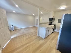 Santa Clara apartment for rent - A kitchen with white cabinets and a black fridge.