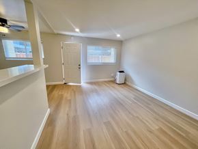 Santa Clara apartment for rent - A room with wooden flooring and a white door.