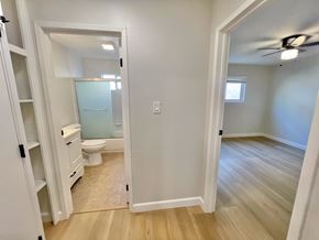 Santa Clara apartment for rent - A small bathroom with a toilet, sink, and a mirror.