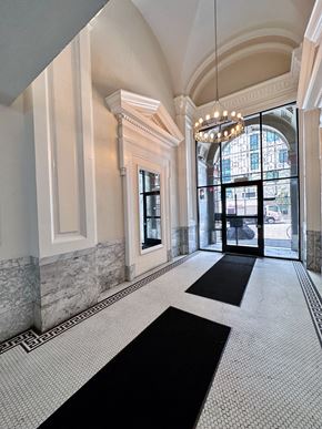San Francisco apartment for rent - a large hallway with a chandelier and large windows