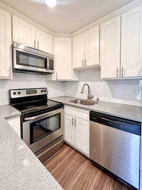 San Mateo apartment for rent - a kitchen with stainless steel appliances and white cabinets