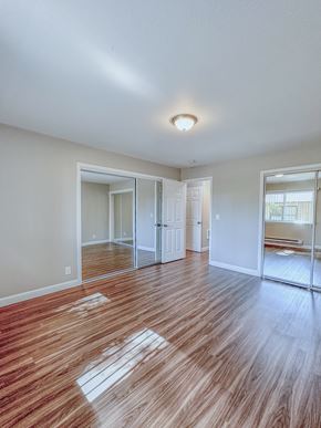 San Mateo apartment for rent - an empty living room with wood flooring and a large window