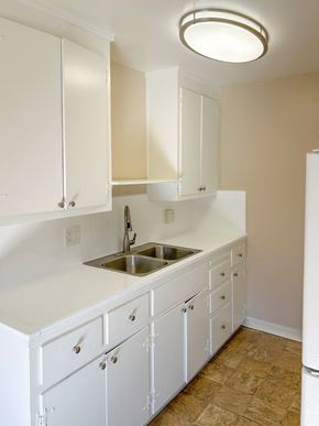 Santa Clara apartment for rent - a kitchen with white cabinets and a sink