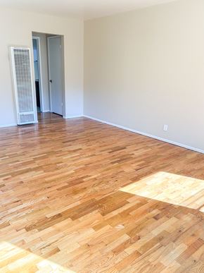 Santa Clara apartment for rent - an empty living room with wood flooring and white walls