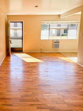 Santa Clara apartment for rent - an empty living room with a hard wood floor and two windows