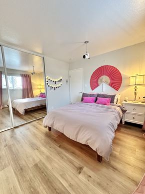 San Jose apartment for rent - a bedroom with a large white bed and a mirror