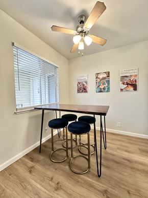 San Jose apartment for rent - a dining room with a table and four stools under a ceiling fan