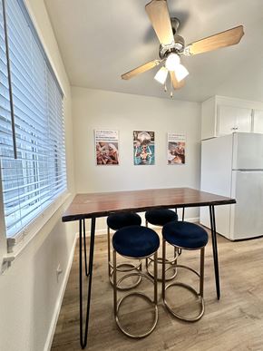 San Jose apartment for rent - a dining area with a table and four chairs and a kitchen with a large window