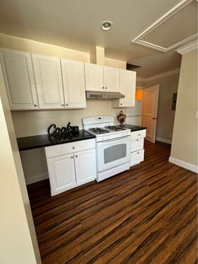 Menlo Park apartment for rent - a kitchen with white cabinets and a white stove top oven