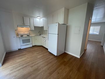 Sunnyvale apartment for rent - A kitchen with white cabinets and a white fridge.