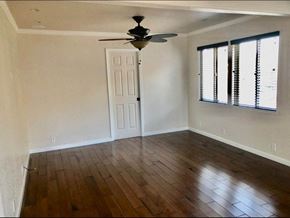Redwood City apartment for rent - a room with a ceiling fan and hardwood floors