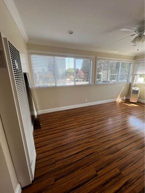 Menlo Park apartment for rent - an empty room with a ceiling fan and three windows