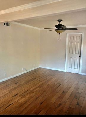 Redwood City apartment for rent - an empty room with a ceiling fan and hardwood floors