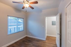 San Jose apartment for rent - an empty bedroom with a ceiling fan and a window