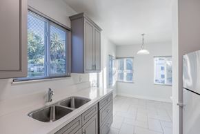 San Jose apartment for rent - an empty kitchen with a sink and a refrigerator