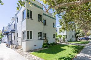 San Jose apartment for rent - the exterior of a white house with a lawn and trees