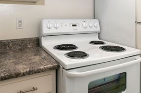 Hayward apartment for rent - a white stove top oven sitting next to a kitchen counter