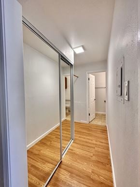 Oakland apartment for rent - Narrow hallway with mirrored sliding closet doors at The Chase Apartments Homes, Oakland, CA