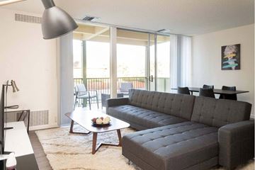 Palo Alto apartment for rent - A grey couch sits in a living room with a coffee table in front of it.