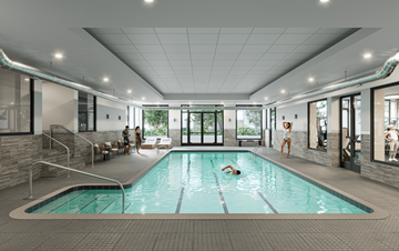 Arlington apartment for rent - A person is swimming in a rectangular pool with a brick patterned floor.