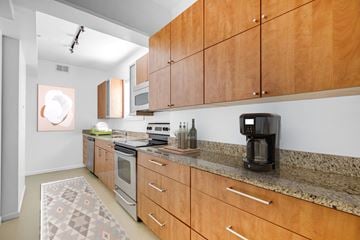 Washington apartment for rent - a kitchen with wood cabinets and granite counter tops and appliances
