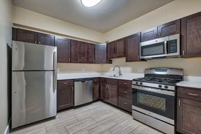 Washington apartment for rent - Kitchen with stainless steel appliances and wooden cabinets at The Argonne Apartments, Washington DC