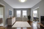 Washington apartment for rent - A living room with a rug on the floor and a television on the right side.