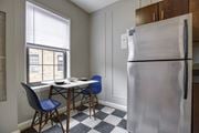 Washington apartment for rent - A kitchen with a table and chairs and a refrigerator.